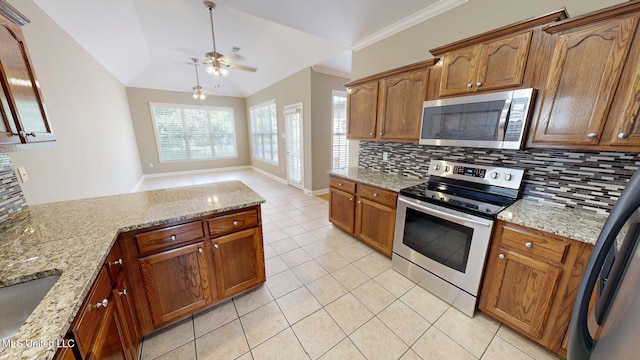 kitchen with stainless steel appliances, light stone counters, decorative backsplash, a ceiling fan, and light tile patterned floors