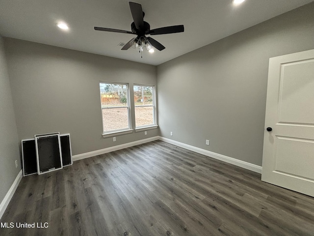 empty room with dark hardwood / wood-style flooring and ceiling fan