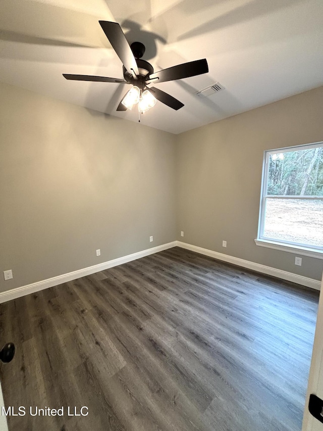 spare room featuring dark hardwood / wood-style floors and ceiling fan