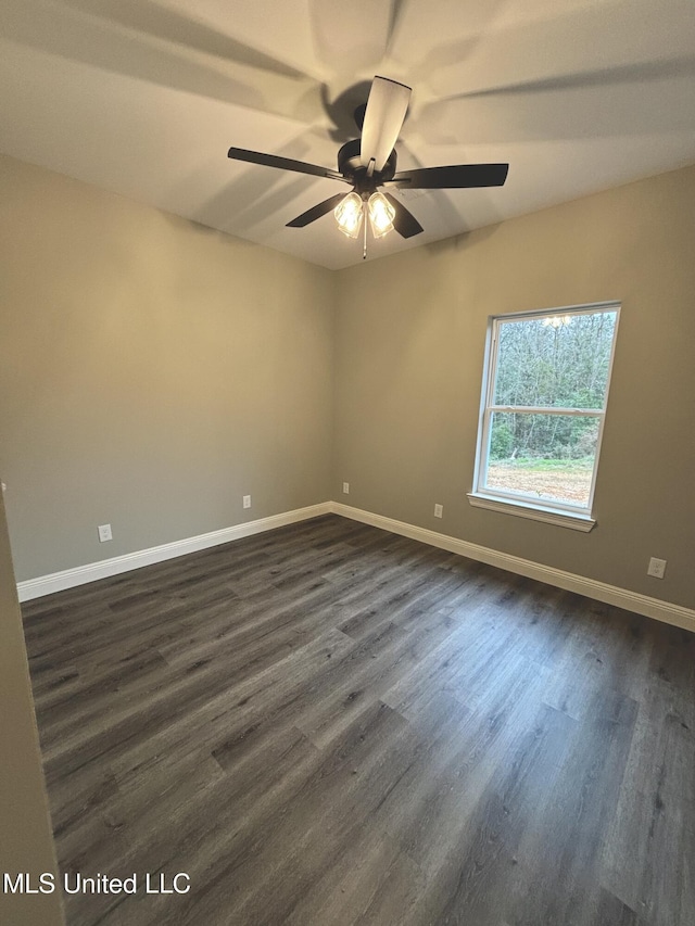 spare room with dark hardwood / wood-style flooring and ceiling fan