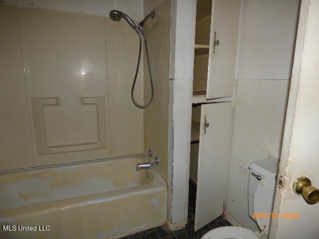 full bathroom with tile patterned floors, toilet, and  shower combination