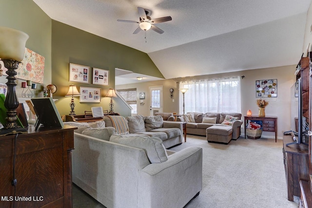 living room with lofted ceiling, carpet flooring, and a ceiling fan