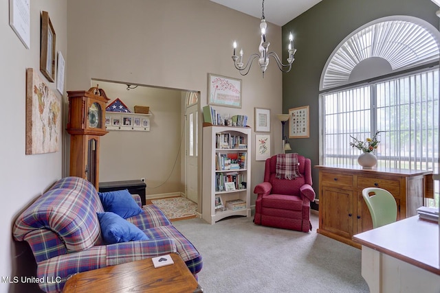 sitting room with light carpet and an inviting chandelier