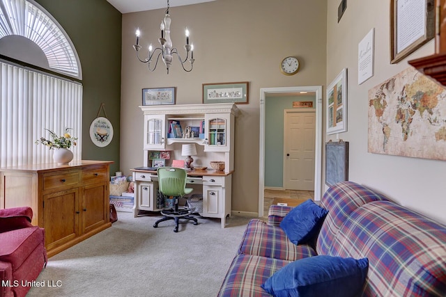 office area featuring visible vents, a high ceiling, a notable chandelier, and light colored carpet