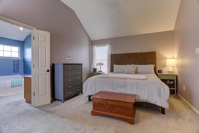 bedroom featuring vaulted ceiling, baseboards, and light carpet