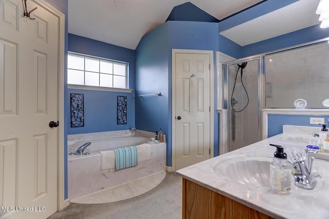 bathroom featuring a shower stall, a garden tub, lofted ceiling, and a sink