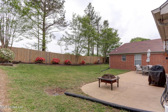 view of yard with a fire pit, a patio, and a fenced backyard