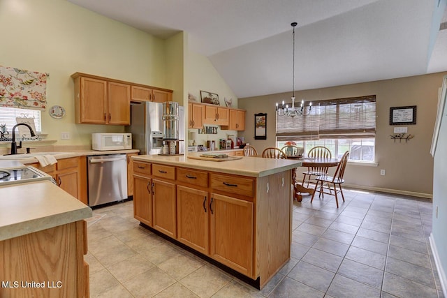 kitchen with stainless steel appliances, a notable chandelier, light countertops, high vaulted ceiling, and light tile patterned floors