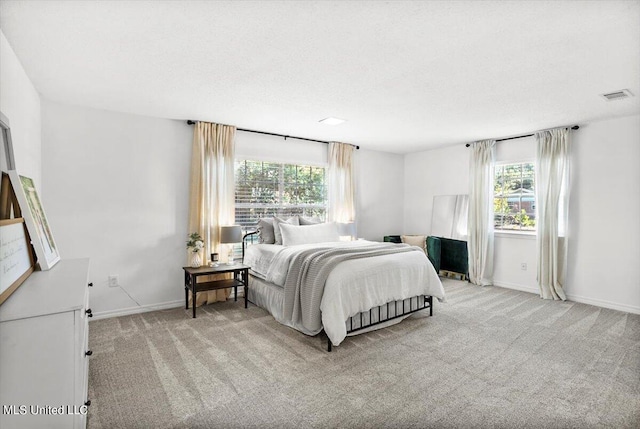 carpeted bedroom featuring multiple windows