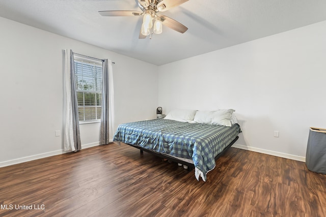 bedroom featuring ceiling fan and dark hardwood / wood-style floors