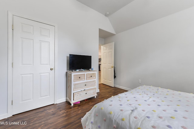 bedroom featuring dark wood-type flooring and vaulted ceiling