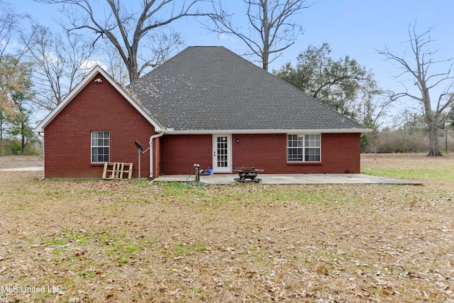 back of property featuring a yard and a patio area