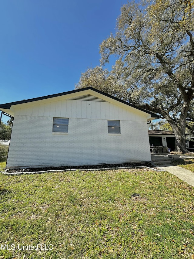 809 Herrick Ave, Pascagoula, MS 39567 - view of property exterior with a lawn and brick siding