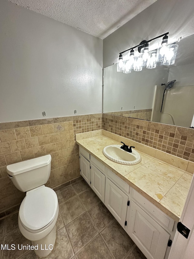 809 Herrick Ave, Pascagoula, MS 39567 - full bath featuring vanity, a textured ceiling, a shower, wainscoting, and tile patterned floors