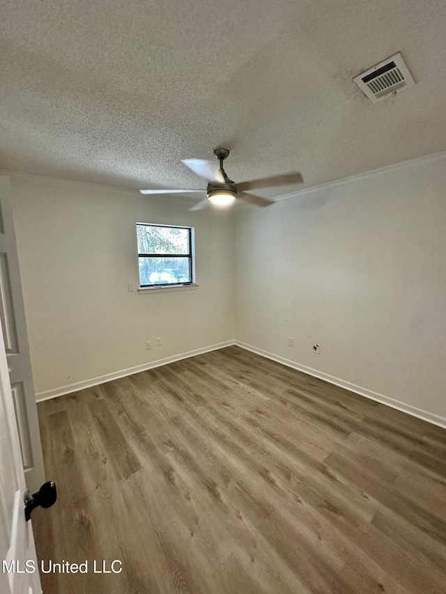 809 Herrick Ave, Pascagoula, MS 39567 - empty room featuring wood finished floors, a textured ceiling, and a ceiling fan