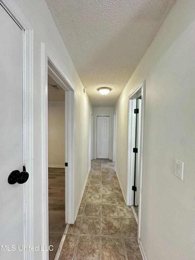 809 Herrick Ave, Pascagoula, MS 39567 - hallway featuring a textured ceiling and baseboards