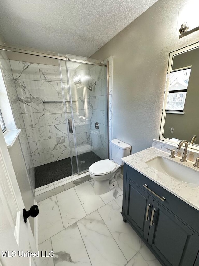 809 Herrick Ave, Pascagoula, MS 39567 - bathroom featuring a textured ceiling, vanity, a shower stall, marble finish floors, and a textured wall