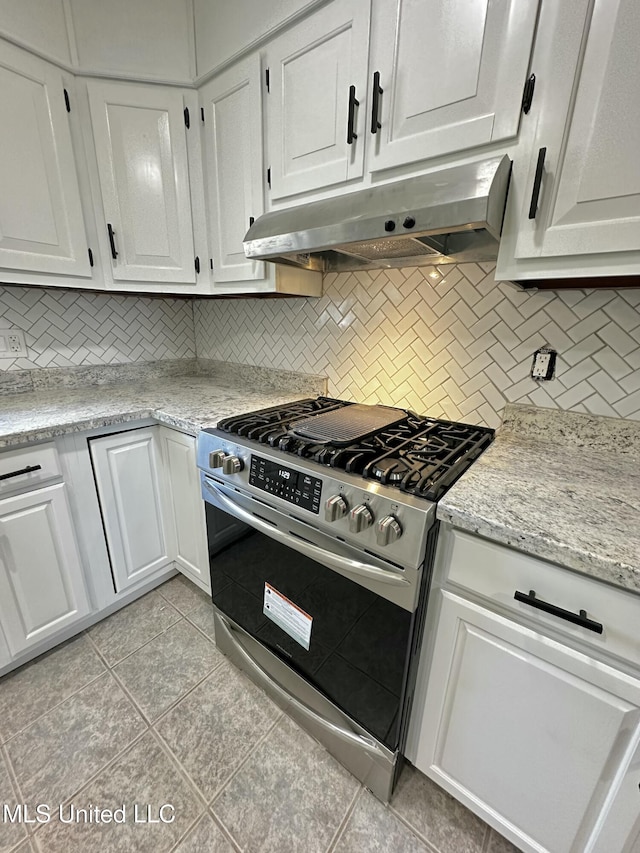 809 Herrick Ave, Pascagoula, MS 39567 - kitchen with gas stove, under cabinet range hood, backsplash, and white cabinetry