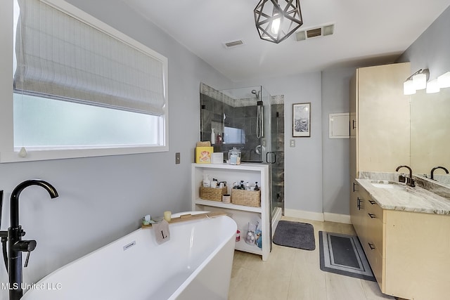 129 Marcie Dr, Long Beach, MS 39560 - full bath with vanity, a freestanding bath, a stall shower, and baseboards