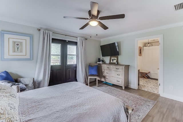 129 Marcie Dr, Long Beach, MS 39560 - bedroom featuring wood finished floors, ornamental molding, baseboards, ensuite bathroom, and a ceiling fan