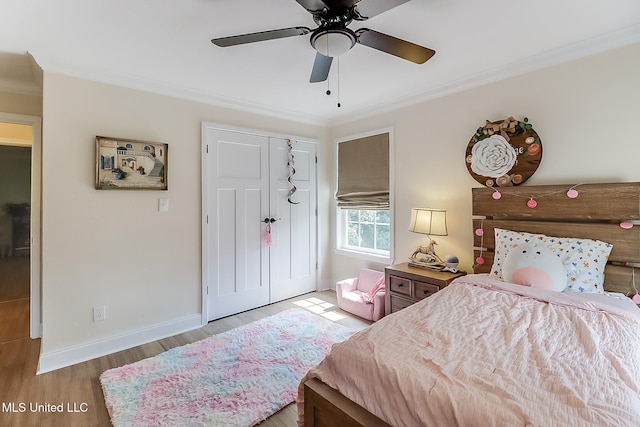 129 Marcie Dr, Long Beach, MS 39560 - bedroom featuring crown molding, wood finished floors, a closet, baseboards, and a ceiling fan