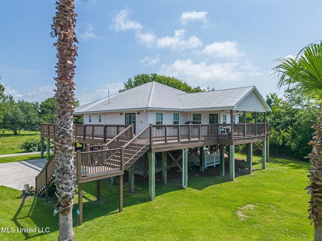 129 Marcie Dr, Long Beach, MS 39560 - rear view of house featuring a deck, a lawn, metal roof, and stairs
