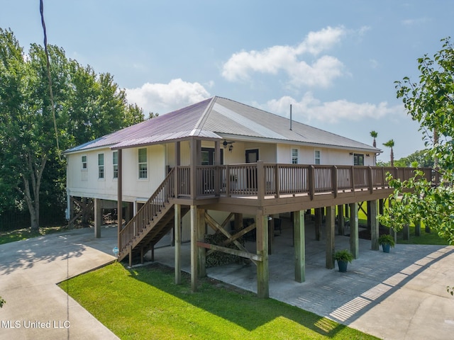 129 Marcie Dr, Long Beach, MS 39560 - back of property featuring metal roof, a lawn, driveway, and a carport