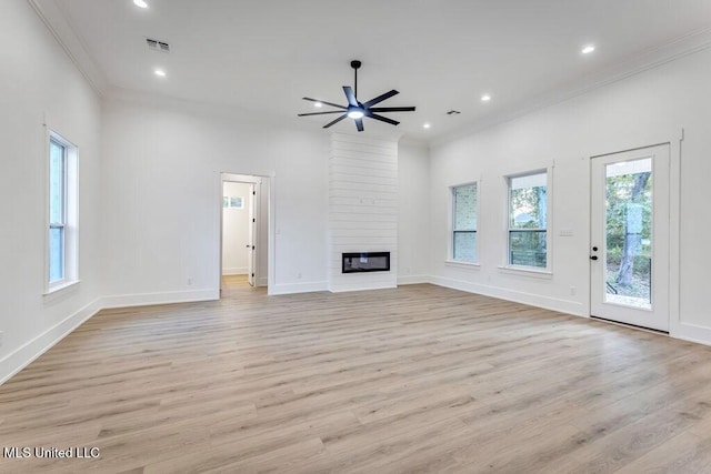 unfurnished living room with a fireplace, light wood-type flooring, ceiling fan, and crown molding