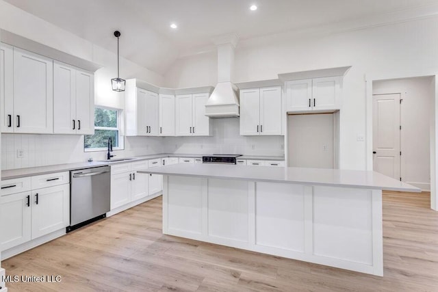 kitchen featuring tasteful backsplash, pendant lighting, dishwasher, and a kitchen island