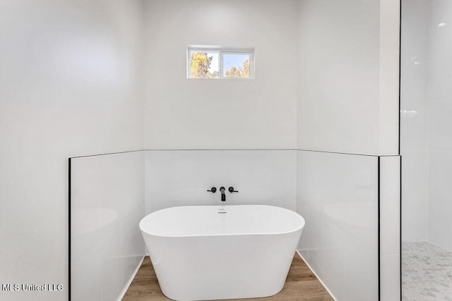 bathroom featuring a bathtub and wood-type flooring