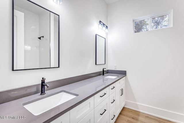 bathroom featuring hardwood / wood-style flooring and vanity