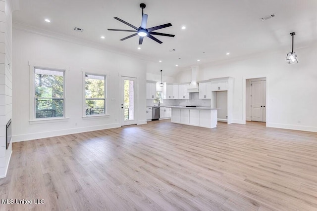 unfurnished living room featuring ceiling fan, light wood-type flooring, and crown molding