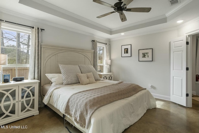 bedroom featuring ceiling fan, ornamental molding, and a tray ceiling