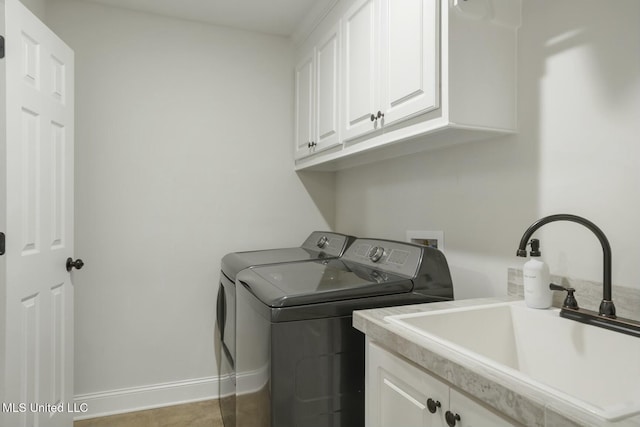 clothes washing area featuring cabinets, separate washer and dryer, and sink