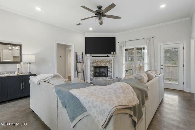 living room with crown molding, ceiling fan, a fireplace, and concrete floors