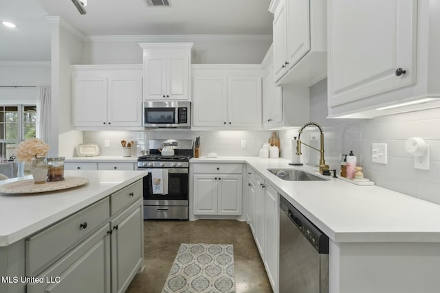 kitchen featuring decorative backsplash, white cabinetry, sink, and stainless steel appliances