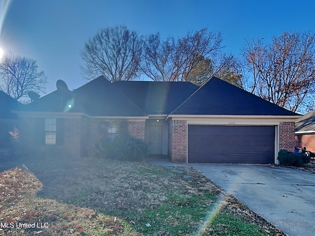 single story home featuring a garage, concrete driveway, and brick siding