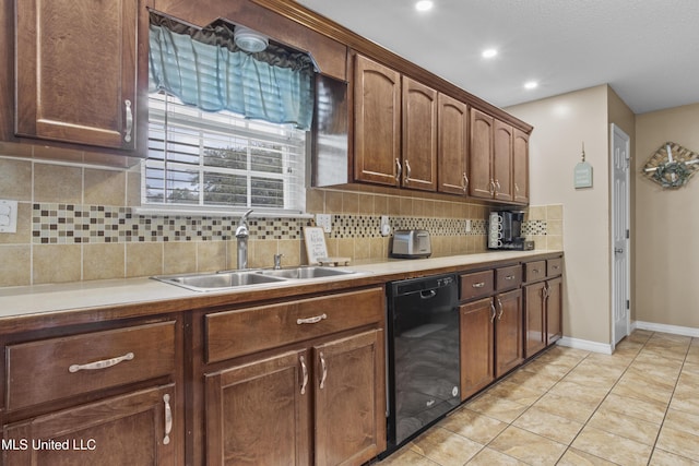 kitchen featuring dishwasher, sink, light tile patterned flooring, and decorative backsplash