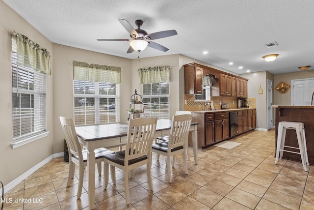 dining room with light tile patterned floors, a textured ceiling, and ceiling fan