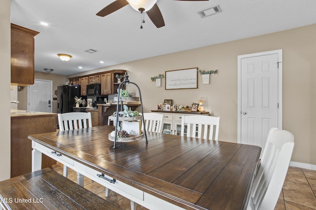 dining room featuring light tile patterned floors and ceiling fan