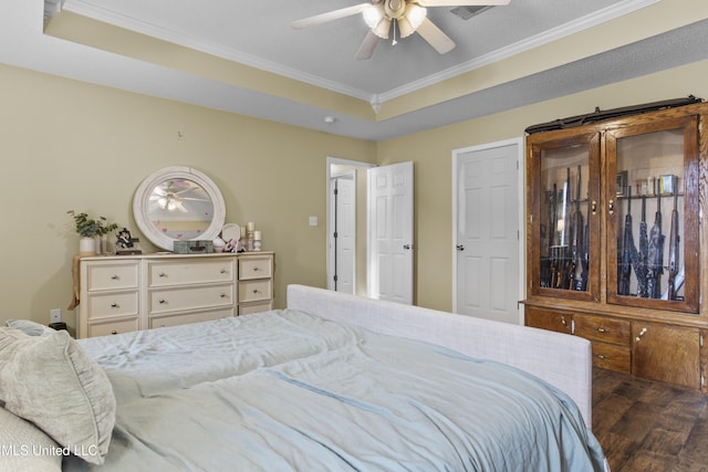 bedroom with crown molding, ceiling fan, dark hardwood / wood-style floors, and a raised ceiling