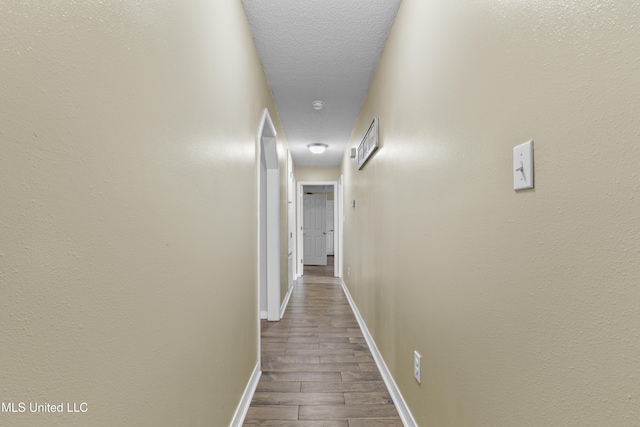 corridor featuring a textured ceiling