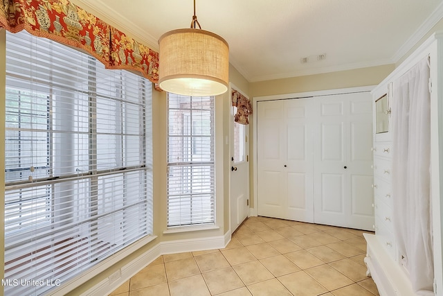 interior space featuring ornamental molding and light tile patterned flooring