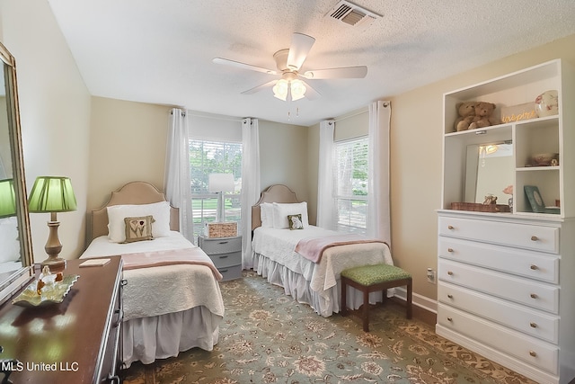 bedroom featuring a textured ceiling and ceiling fan