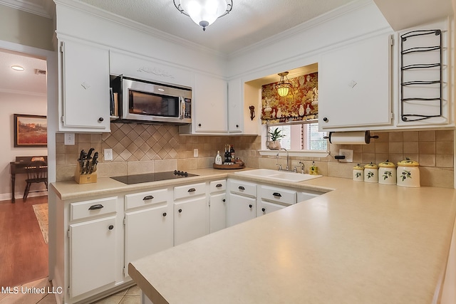 kitchen featuring sink, white cabinetry, and light hardwood / wood-style flooring