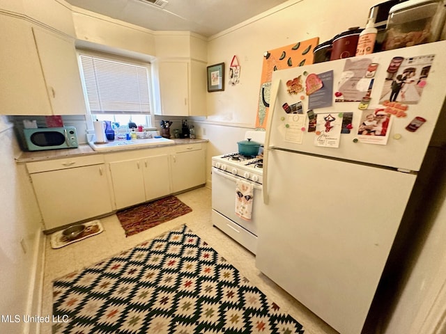 500 Avery St, Cleveland, MS 38732 - kitchen with white appliances, a sink, light countertops, and white cabinetry