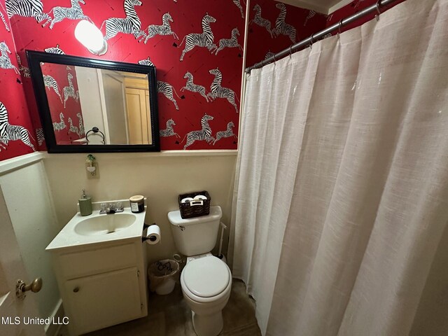 500 Avery St, Cleveland, MS 38732 - bathroom with a wainscoted wall, toilet, wallpapered walls, and vanity