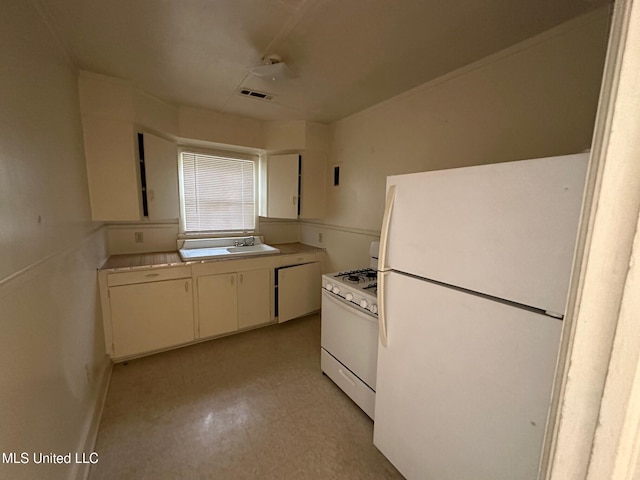 500 Avery St, Cleveland, MS 38732 - kitchen featuring white appliances, a sink, light countertops, light flooring, and white cabinets