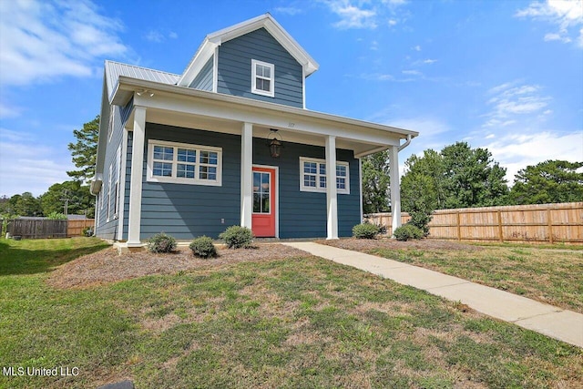 view of front facade with a front lawn and ceiling fan