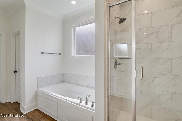 bathroom with separate shower and tub and hardwood / wood-style flooring